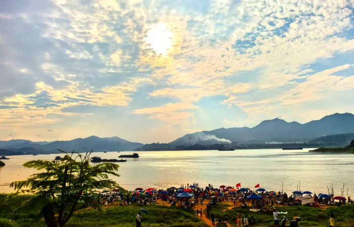蓝天白云下，阳光沙滩上，湾边村游客络绎不绝，欢笑声不断