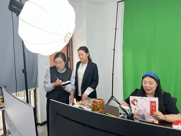 任锦（右一）记录直播信息