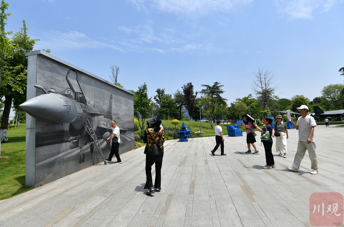 市民在成飞公园打卡拍照。