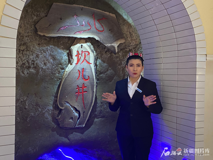 吐尔逊娜依·胡吉艾合买提在坎儿井地下暗渠讲解。石榴云/新疆日报记者 赵梅摄