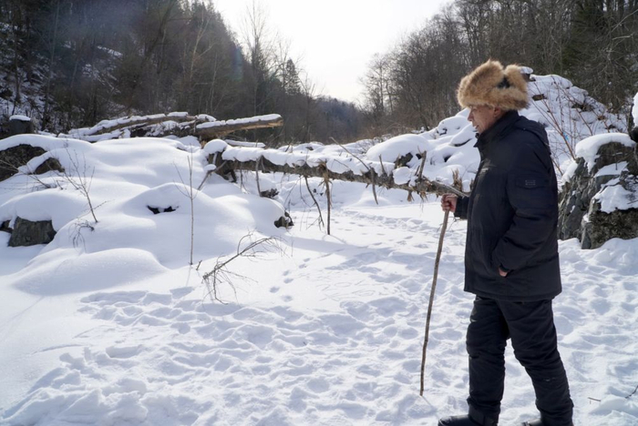 1月26日，长白山“老把头”田守仁行走在被雪覆盖的松江河冰面上。（孙逸轩 摄）