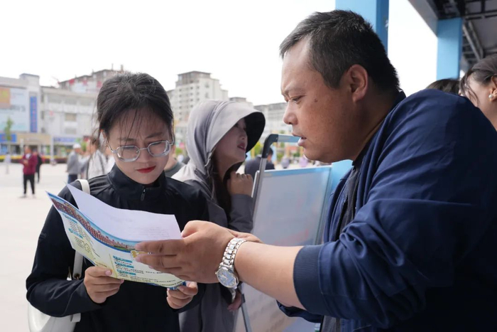 企业工作人员向求职人员介绍情况