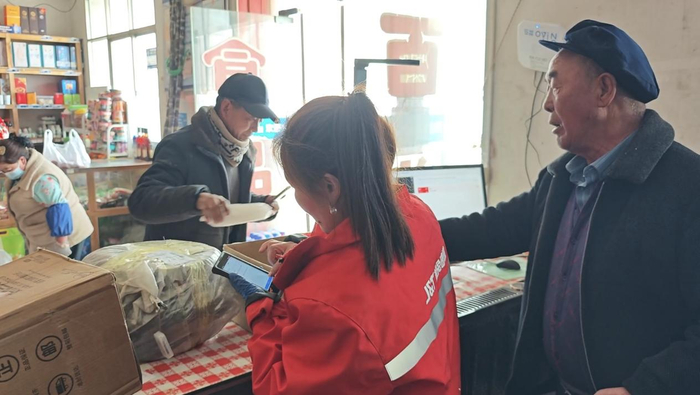 包裹卸车后有附近村民来这里取件（记者江晓晨  摄）