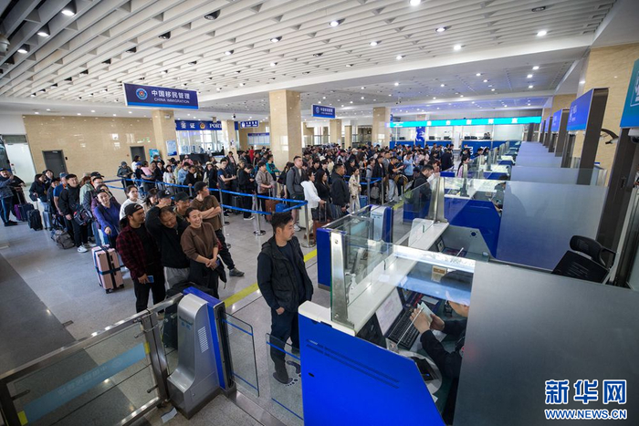 5月19日，二连出入境边防检查站移民管理警察有序为旅客办理通关手续。新华网发（郭鹏杰 摄）