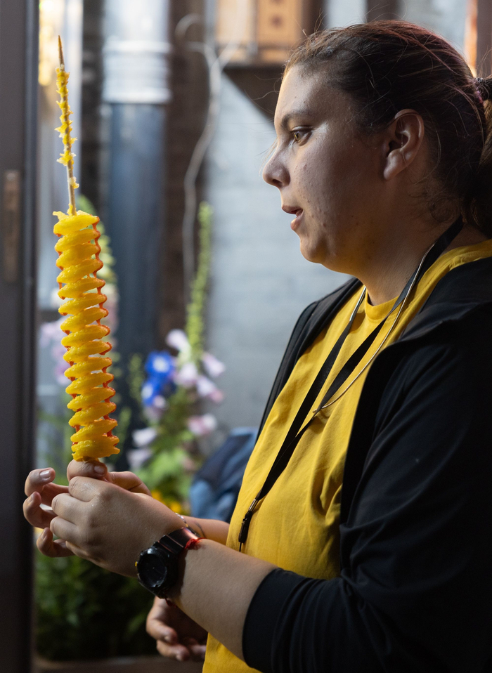 5月16日，什刹海，外国游客新奇地看着手中的黄金薯塔。