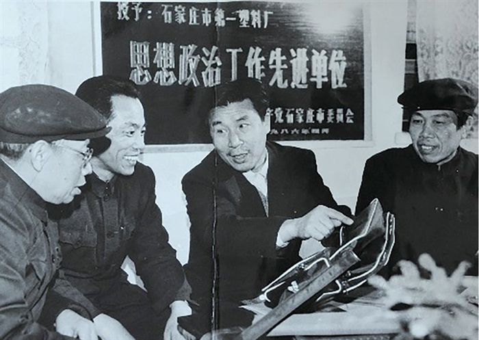 张兴让（右二）和同事商讨产品生产