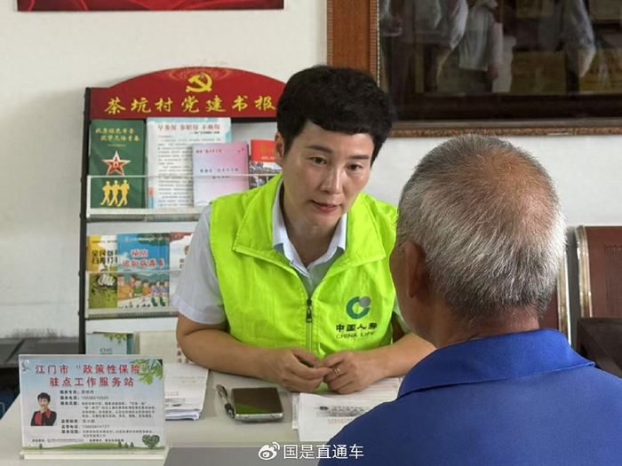 5月22日，江门市“政策性保险”驻点工作服务站的工作人员为老人介绍“银龄安康”普惠保险事宜。王东宇 摄