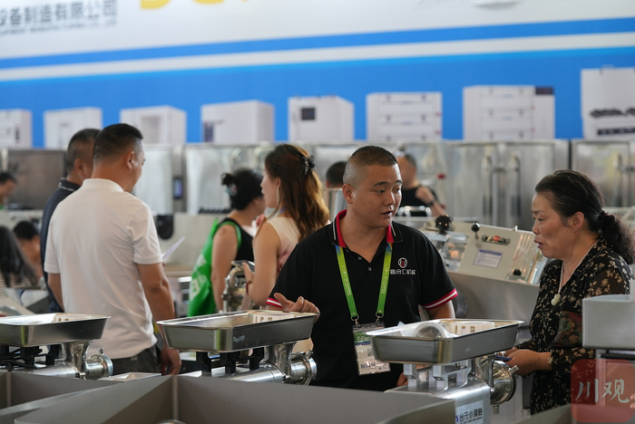 各式各样的餐饮厨具电器设备也是博览会一大看点，许多客商正在和展位销售人员沟通洽谈