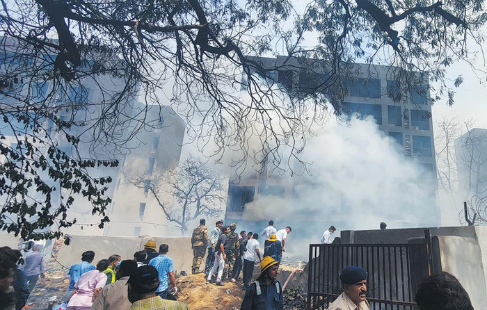 人们在客机失事现场进行救援。　新华社/印度联合新闻社