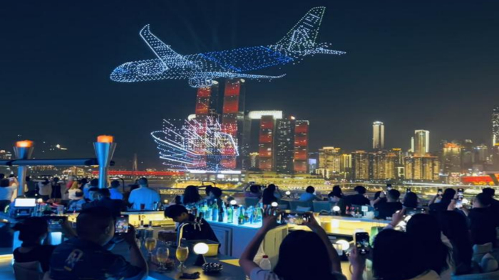 游客们在重庆之眼天台吧观看无人机灯光秀（央广网发  受访者供图）