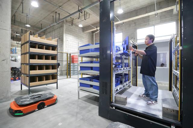 快仓（宝山）全球智能机器人研发总部，新一代“货到人”拣选工作站，货架对接≤4秒，配备重力脚轮灵活移动。蒋迪雯摄