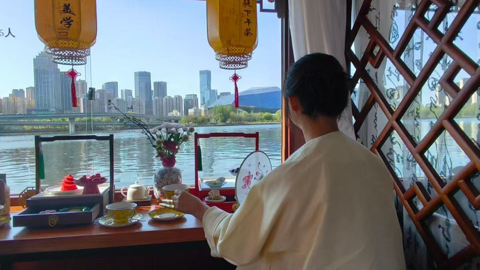 游客一边欣赏河景，一边品尝特色下午茶（央广网发  沈阳浑河航运经营有限公司供图）