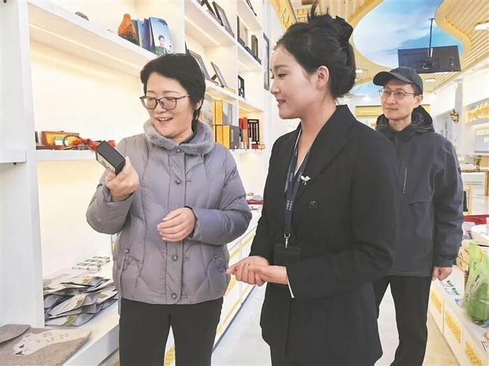 周振霞（左一）在玉树州农产品体验店了解产品情况。程宦宁 摄