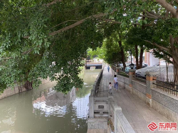 居民在河边散步。