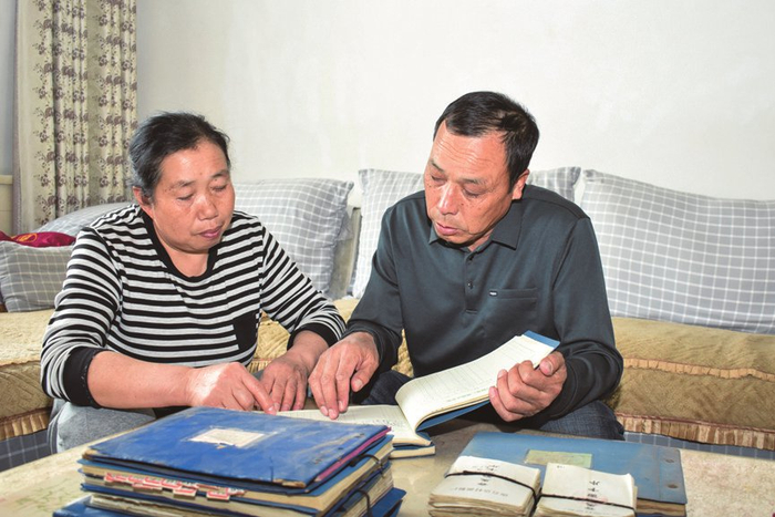 重翻账本，刘平贵、李继林夫妇满心感慨。宁绍雄摄