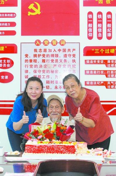 孙建学(右一)和志愿者廖宏瑜一起给孙洪秀庆祝生日。 唐明洋/摄