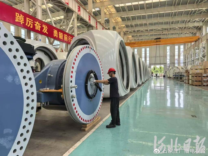 6月17日，河北运达风电设备有限公司厂房内，员工正在为风机主轴安装电滑环盖板。河北日报记者 刘剑英摄