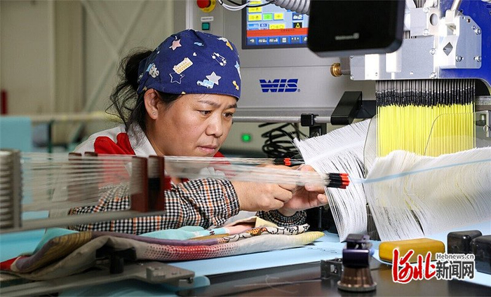 7月15日，河北鹤煌网业股份有限公司工人正在进行丝网插接作业。 河北日报记者 李佳泽摄