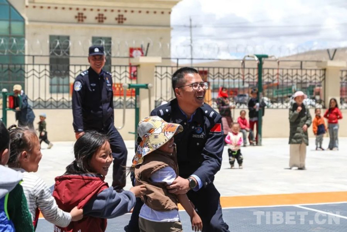图为民警与孩子们一起做游戏