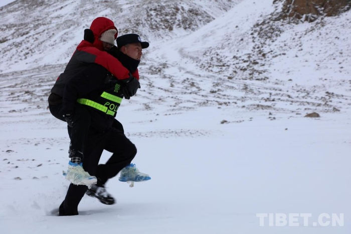 图为塔尔钦边境派出所民警在雪中实施救援受访者供图