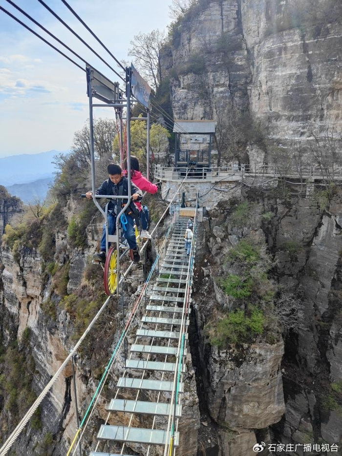 游客在河北省涞源县白石山景区体验高空自行车。新华社记者王昆 摄