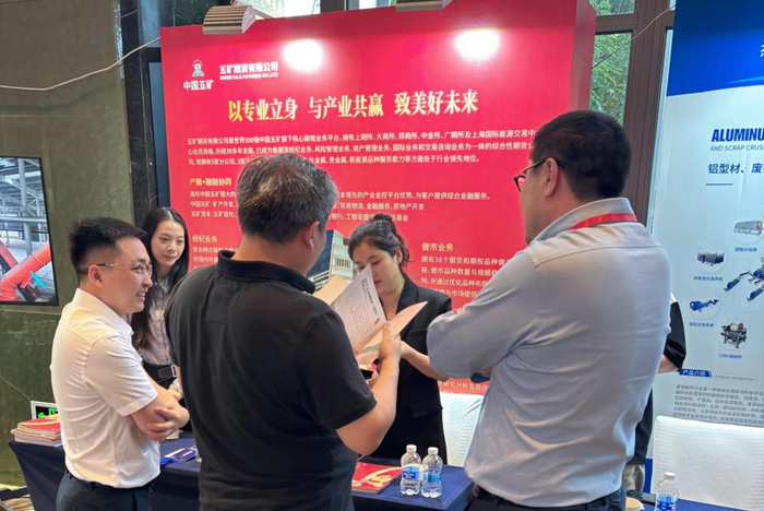 图：五矿期货工作人员在展位与参会嘉宾交谈