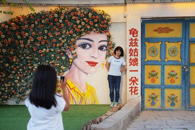 游客在新疆库车市龟兹小巷拍照（7月17日摄）。新华社记者 李笑 摄