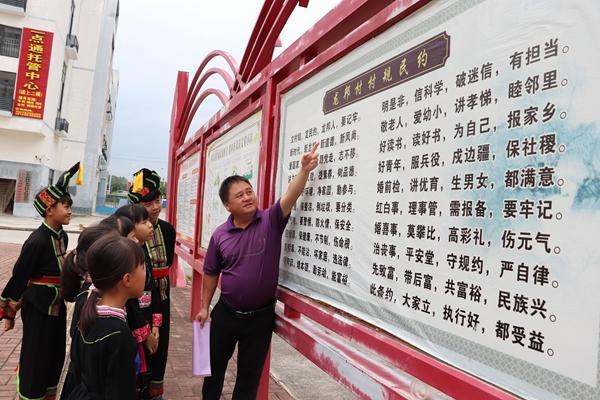 百色市田东县思林镇龙邦村党总支部书记蓝茂东带领龙邦儿童传唱村规民约。思林镇政府供图