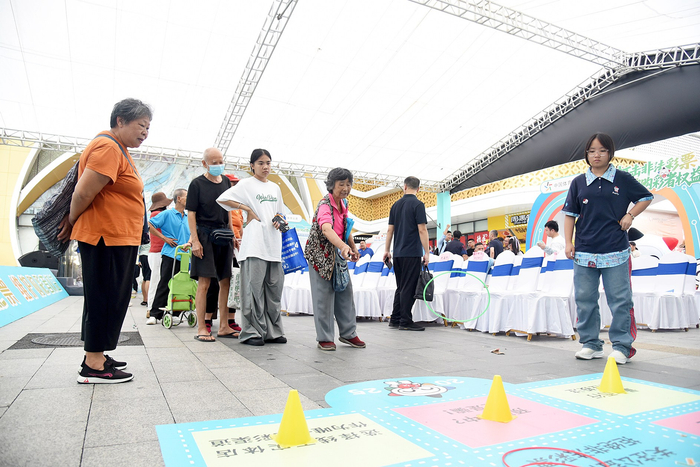     市民参与趣味游戏。    本报记者韦峭 摄
