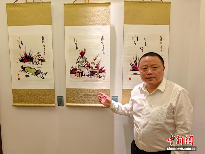  7月18日，丰子恺之孙、丰子恺研究会会长丰羽在上海接受中新社专访时介绍丰子恺画作《轰炸》。　　范宇斌 摄