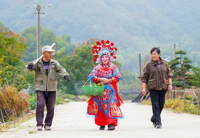 村民在排练间隙到田里摘菜（央广网发  缪小芬  摄）