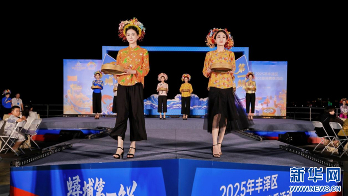 在“簪花宴上菜秀”上，模特们手托“头鲜”佳肴，展现独特的饮食文化。新华网发（丰泽区委宣传部 供图）