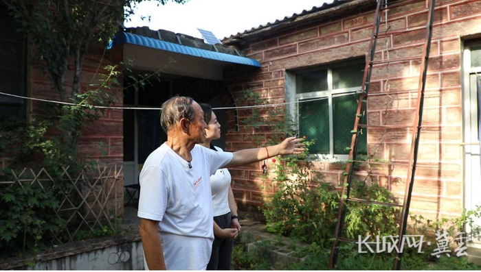 邢台市坡子峪村村民李更臣向记者介绍老院东屋曾住过八个抗大女学员。长城网·冀云客户端记者 李全 摄