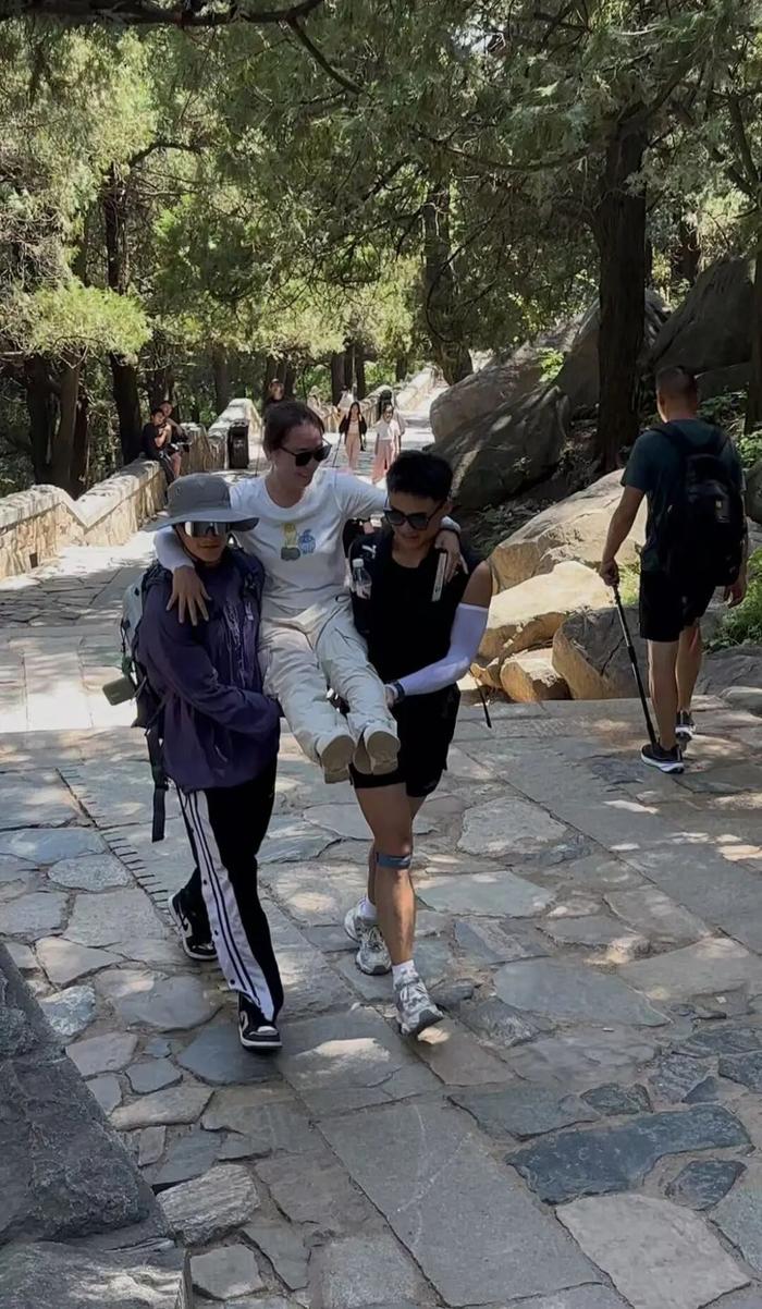 两位陪爬员抬着游客登山(受访者供图)