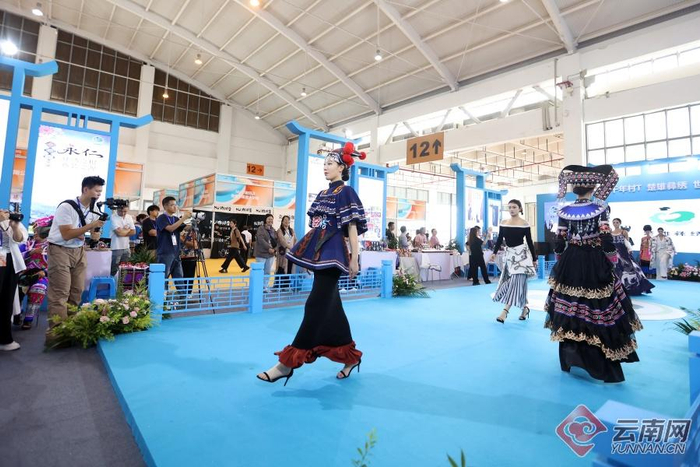 图为9月18日,楚雄展台,模特们身着14套融合传统与现代的彝绣服饰轮番登场,引来现场观众关注。记者 陈飞 高吴双 摄