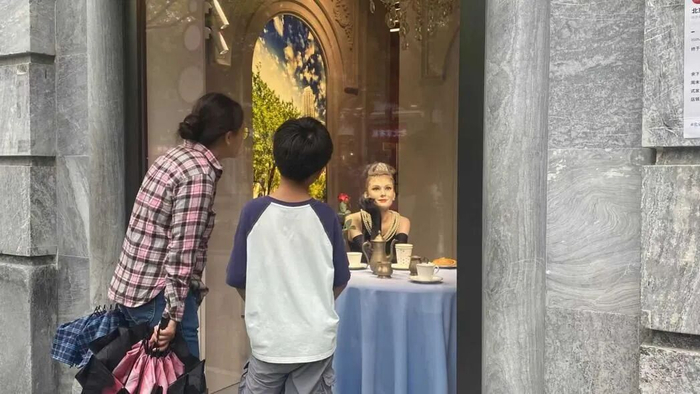 　　一对母子在北京杜莎夫人蜡像馆外观看 图片来源：每经记者 毕媛媛 摄