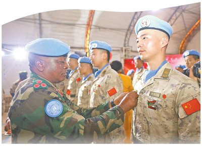 联阿安全部队军官为中国第五批赴阿卜耶伊维和直升机分队官兵授勋。秦英章摄