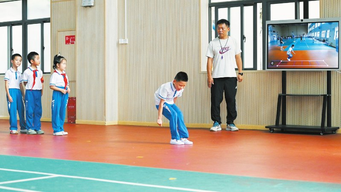 海景学校的学生使用智慧体育设备进行跳远比赛。