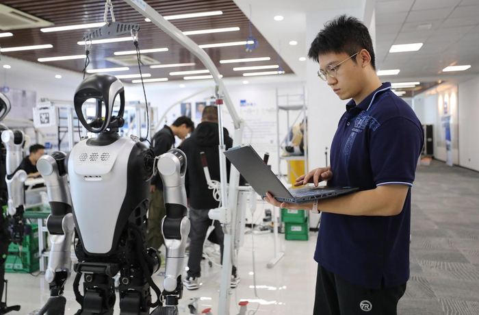 张鸿伟查看电脑上人形机器人的运行数据