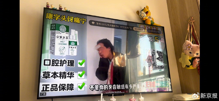 ​康字头云南本草伢痛宁草本护理喷剂的电视贴片广告。图/新京报记者 张秀兰 摄