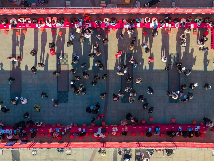 2025年1月15日，求职者在招聘会现场了解招聘信息（无人机照片）。（图源：新华社）