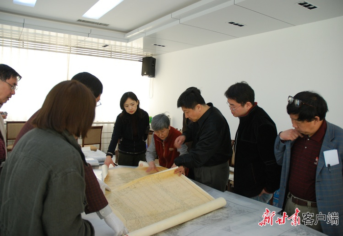 2007年，敦煌石窟考古报告编写组评议手工测绘图。（敦煌研究院供图）