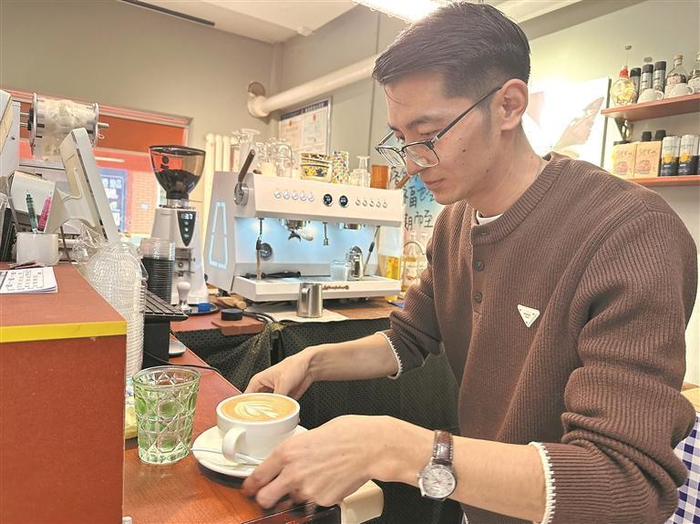 阿旺克知正在做咖啡。本报记者 王晶 摄