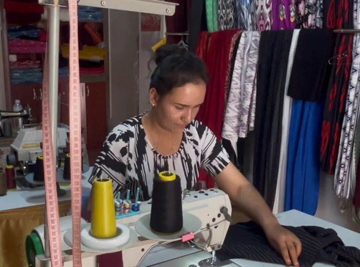 　　喀什地区伽师县英买里镇英买里村的维吾尔族妇女在服装店内忙碌。庞博 摄