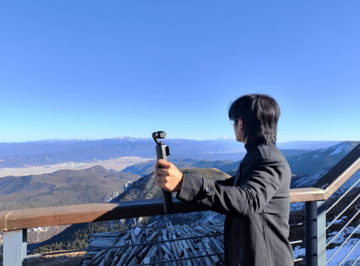 越南知名博主黎日观在石卡雪山山顶进行视频创作