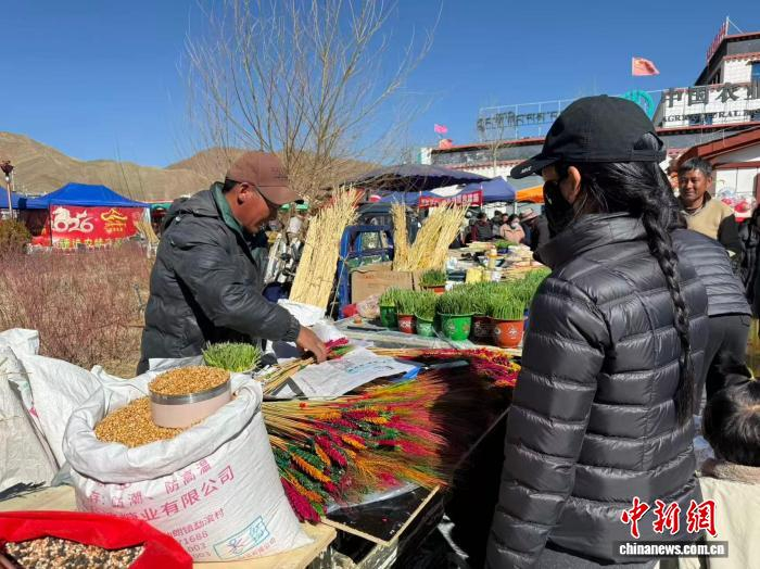 圖為民眾正在選購傳統(tǒng)藏式年貨“羅薩美朵”。澤塔雍措 攝