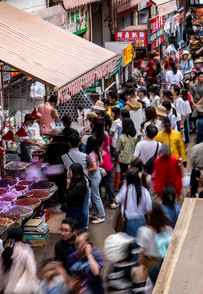 　　游客在昆明市大观篆新农贸市场排队购买“网红小吃”。新华社记者江文耀 摄