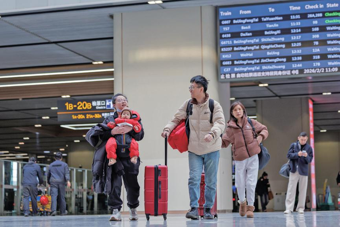 2月2日，春运首日，北京丰台站，家长带着小朋友走进候车大厅。　新京报记者　王子诚　摄