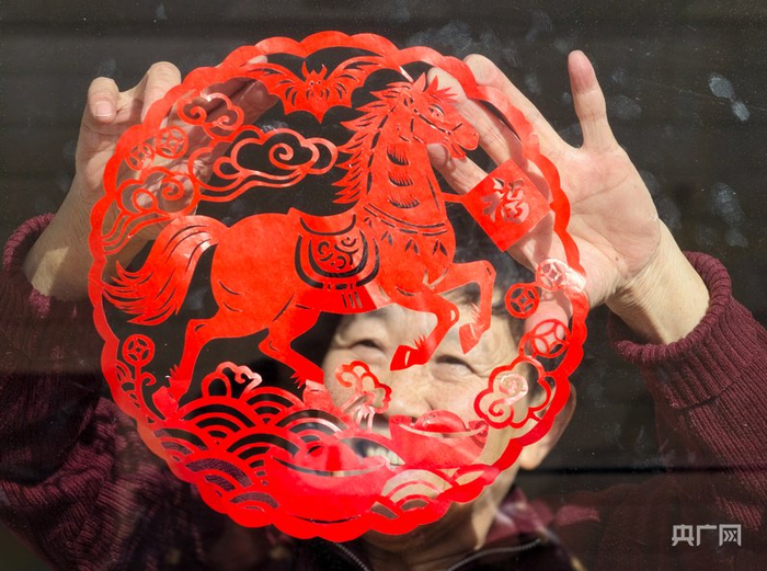 贴上自己剪制的窗花（央广网记者  张海东    摄）