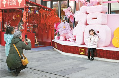 2月10日，市民在北京隆福寺街区的新春市集上拍照留念 供图/新华社